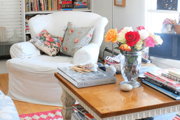 Photo of a coastal living room with vintage floral throw pillows to illustrate the vintage patterns trend